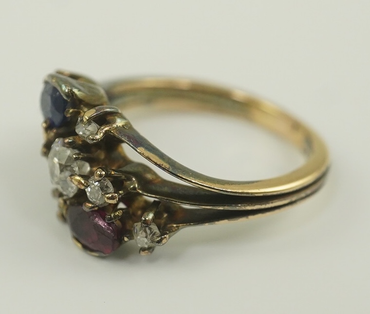 An early 20th century style gold, ruby, sapphire and diamond cluster set triple shank ring